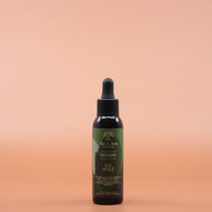 Das Haarpflegeprodukt AS I AM Rosemary Oil 60ml in der Vorderansicht vor einem braun-orangen Hintergrund.