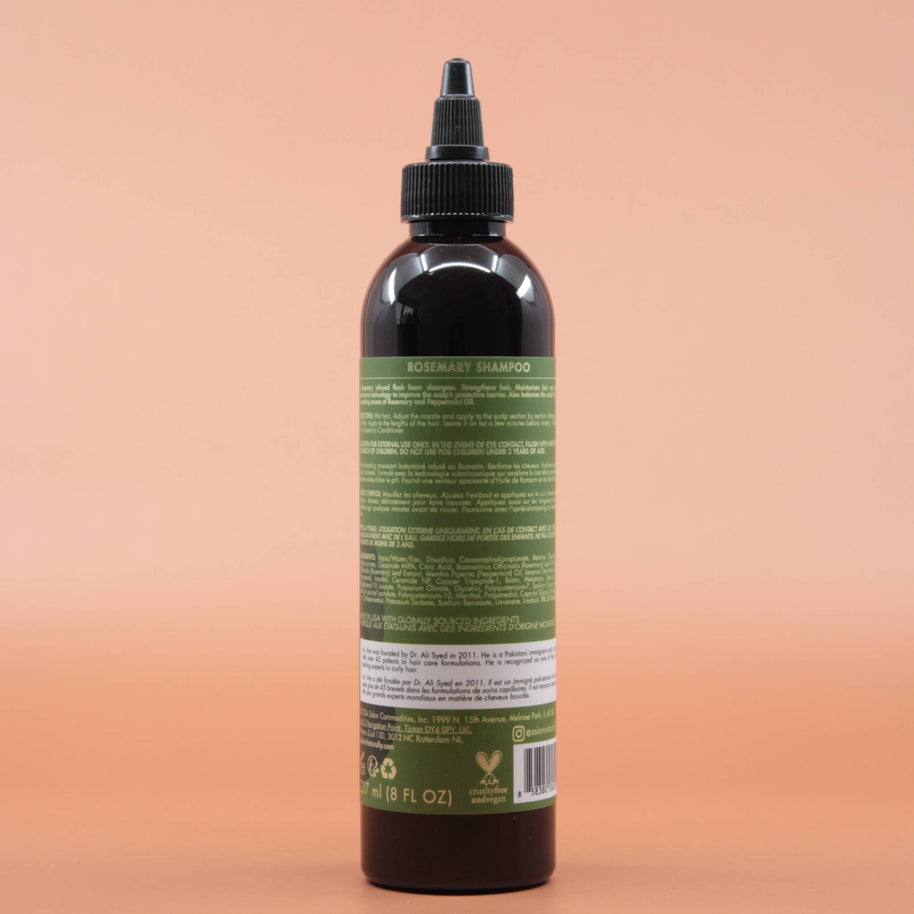 Das Haarpflegeprodukt AS I AM Rosemary Shampoo 237ml in der Rückansicht vor einem braun-orangen Hintergrund.