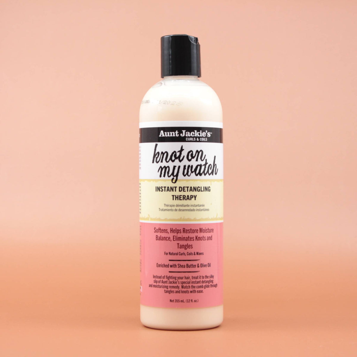 AUNT JACKIES Knot on my watch Instant Detangling Therapy 355ml in der Vorderansicht vor einem braun-orangen Hintergrund