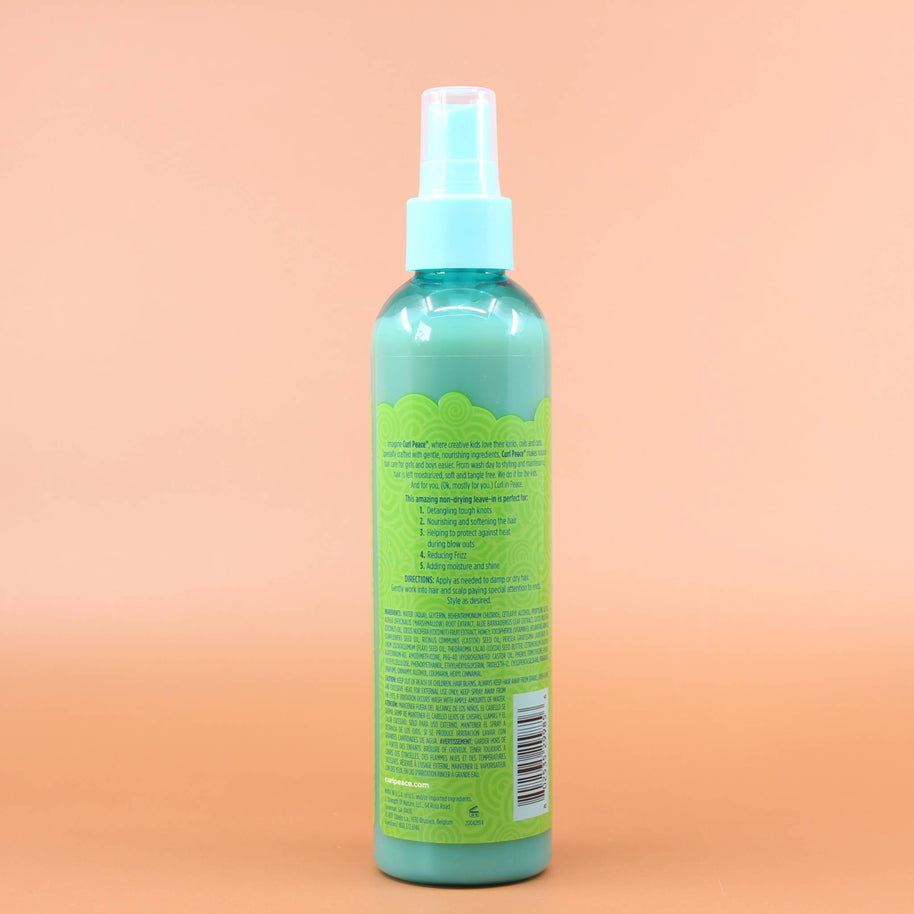 Das Produkt JUST FOR ME Curl Peace 5-in-1 Wonder Spray 237ml Rückansicht vor einen Braun-Orangenen Hintergrund