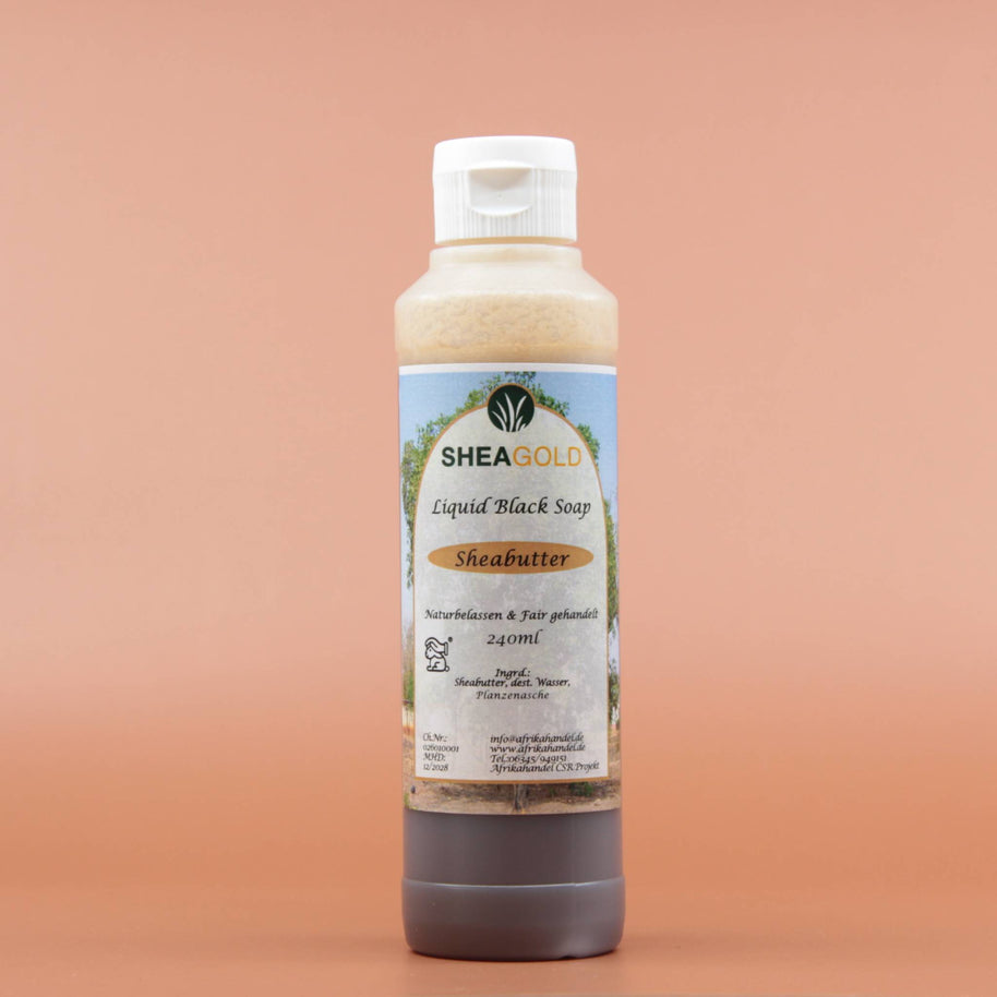 Das Hautpflegeprodukt SHEA GOLD Liquid Black Soap 240ml in der Vorderansicht vor einem braun-orangen Hintergrund.